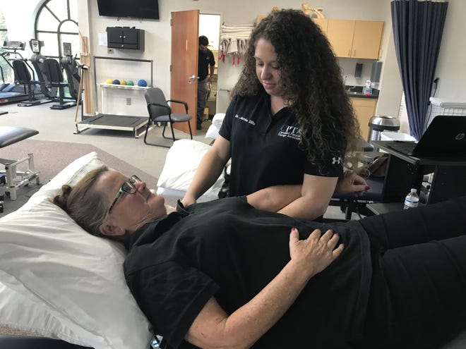 Dr. Jamie Dills of Cleveland Physical Therapy Associates works with Helen Hashbarger on a shoulder injury. [Joyce Orlando/The Star]
