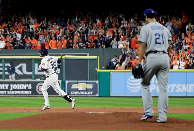 Houston Astros' Yuli Gurriel celebrates his home run past Los Angeles Dodgers starting pitcher Yu Darvish, of Japan, during the second inning of Game 3 of baseball's World Series Friday, Oct. 27, 2017, in Houston.