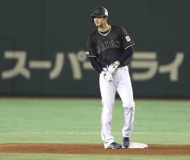 Japan's designated hitter Shohei Otani returns to second base after his fly ball was was ruled a ground-rule double in the seventh inning of an international exhibition series baseball game against the Netherlands at Tokyo Dome in Tokyo, Sunday, Nov. 13, 2016. Pitcher Otani added to his reputation as a powerful hitter when he hit a fly ball that didn't come down. [AP file photo/Toru Takahashi]