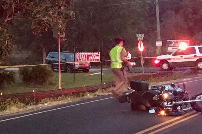 A Florida Highway Patrol trooper works at the scene of a fatal accident involving a motorcycle on County Road 42 Wednesday evening. The motorcyclist, Thomas Dunkle, 58, of Ocklawaha, was pronounced dead at the scene. [Austin L. Miller/Star-Banner]