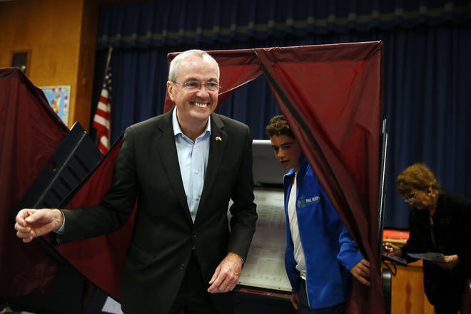 Democrat Phil Murphy exits the polling booth with his youngest son Sam, after voting at the Fairview School on Tuesday, Nov. 7, 2017 in Middletown, N.J. Murphy is facing Republican Lt. Gov. Kim Guadagnoto to replace Gov. Chris Christie, the two-term, term-limited incumbent.  (Bob Karp/The Daily Record via AP)