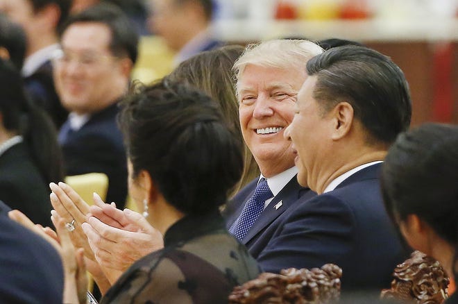 U.S. President Donald Trump and China's President Xi Jinping attend at a state dinner at the Great Hall of the People in Beijing, China, Thursday. [THOMAS PETER/ASSOCIATED PRESS]