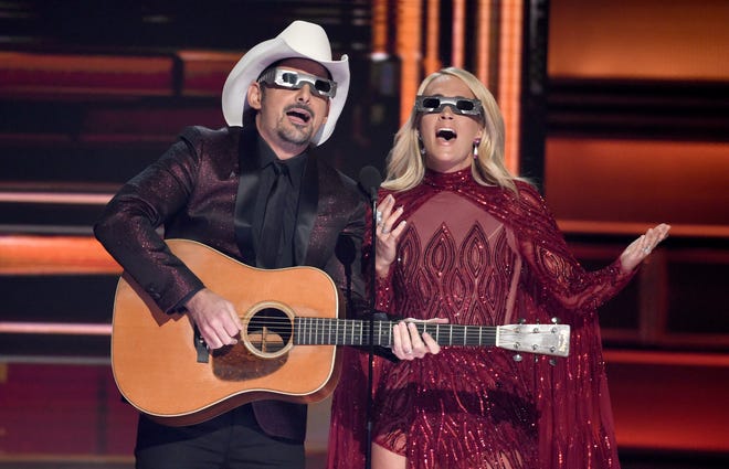 Hosts Brad Paisley, left, and Carrie Underwood speak during the 51st annual CMA Awards at the Bridgestone Arena on Wednesday, Nov. 8, 2017, in Nashville, Tenn. [Photo by Chris Pizzello/Invision/AP]