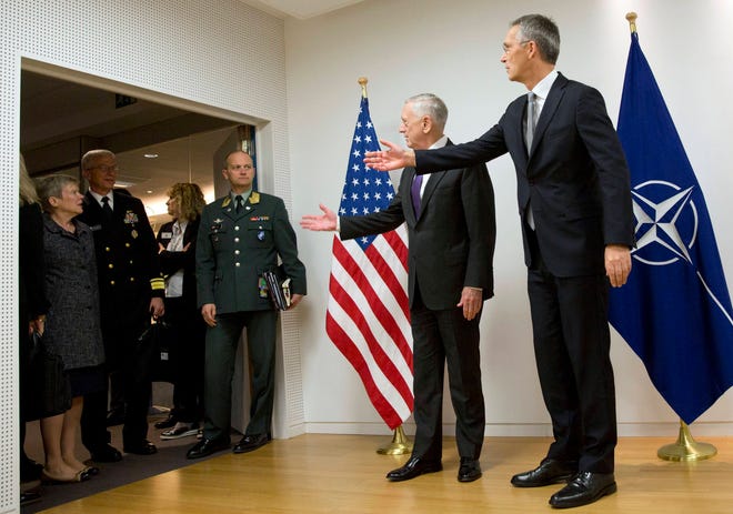 U.S. Secretary for Defense Jim Mattis, center, and NATO Secretary General Jens Stoltenberg, right, gesture to delegation members outside the room prior to a meeting on the sidelines of a NATO defense ministers meeting at NATO headquarters in Brussels on Wednesday, Nov. 8, 2017. NATO defense ministers start two days of talks looking to expand the military alliance’s command structure and drum up more troop contributions for Afghanistan. (AP Photo/Virginia Mayo, Pool)