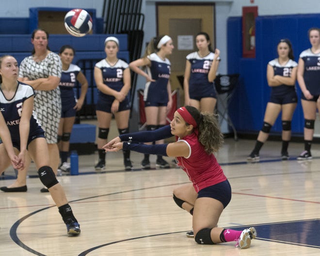 Apponequet's Savannah Quintal goes down low for the dig Monday night during an MIAA Division 2 Tournament quarterfinal against Norwood. [Bud Morton/The Gazette/SCMG]