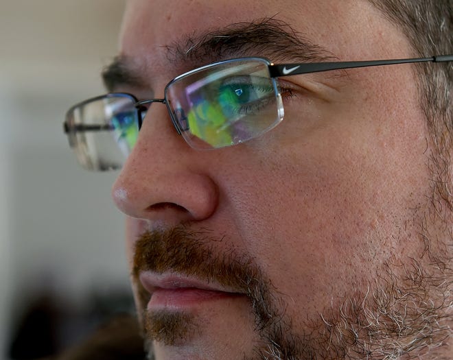 Dominic Gargliardi's glasses reflect the results of his DNA test kit as he checks his computer. [NANCY ROKOS / STAFF PHOTOJOURNALIST]