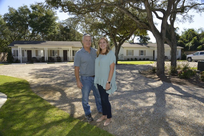 Father-daughter team Mike Shoults and Erin Hadaway of Southern Rentals and Real Estate stand in front of thier new short-term rental venue Cottages by the Bay in Destin. [SAVANNAH VASQUEZ/THE LOG]