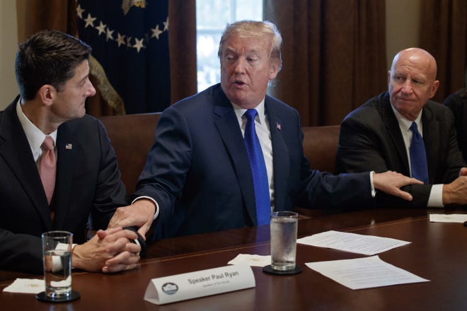 President Donald Trump speaks during a Nov. 2 meeting on tax policy in the White House's Cabinet Room with House Speaker Paul Ryan of Wisconsin, left, and House Ways and Means Committee Chairman Kevin Brady of Texas, right. [AP PHOTO]