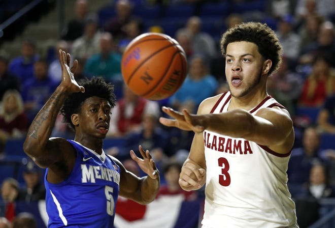 Alabama forward Alex Reese passes the ball past Memphis guard Kareem Brewton Jr. in the second half of an NCAA college basketball game at the Veterans Classic tournament in Annapolis, Md., Friday, Nov. 10, 2017. (AP Photo/Patrick Semansky)