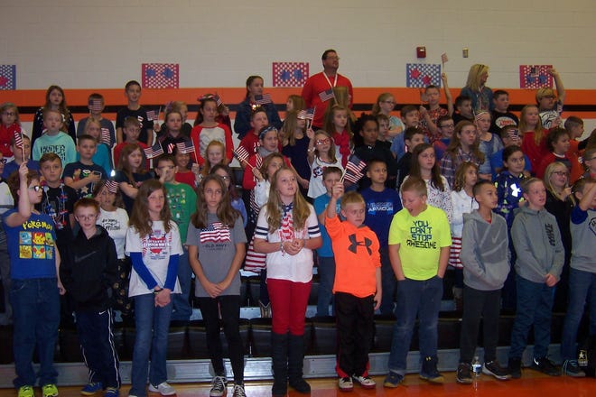 (TimesReporter.com/Barb Limbacher)

Some Strasburg Elementary students wave flags for veterans Friday during a breakfast and celebration.