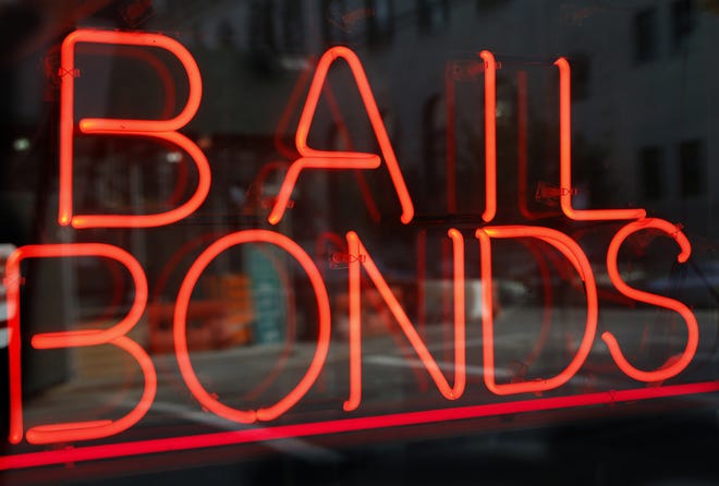 In this Tuesday, July 7, 2015, file photo, a sign advertising a bail bonds business is displayed near Brooklyn's jail and courthouse complex in New York. A national effort is launching that aims to help low-income defendants get out of jail by bailing them out as their criminal cases progress through the courts. [Associated Press file]