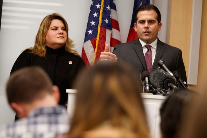 Resident Commissioner Jenniffer Gonzalez-Colon, who represents Puerto Rico as a nonvoting member of Congress, listens as Puerto Rico Gov. Ricardo Rossello speaks during a news conference to urge Congress to include Puerto Rico in the Supplemental Disaster Relief Package, Monday, Nov. 13, 2017, in Washington. (AP Photo/Evan Vucci)