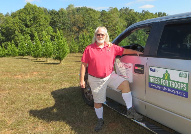File photo Greg Smith on his Christmas tree farm is selling sponsorships in the Trees for Troops program.