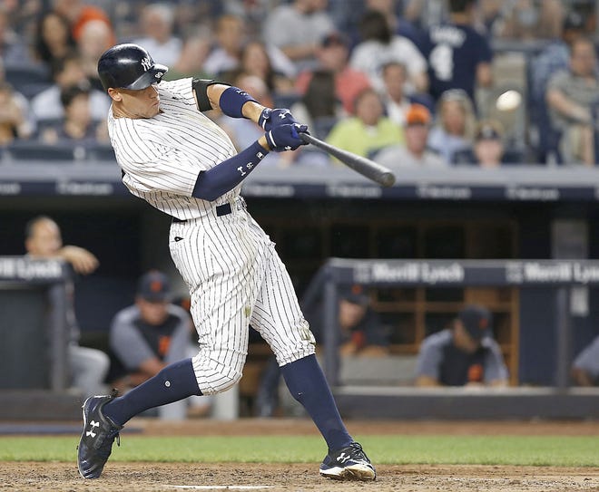 Aaron Judge hits a solo home run during the fifth inning of the New York Yankees' July 31 game against the Detroit Tigers at Yankee Stadium.        [Kathy Willens / Associated Press File]