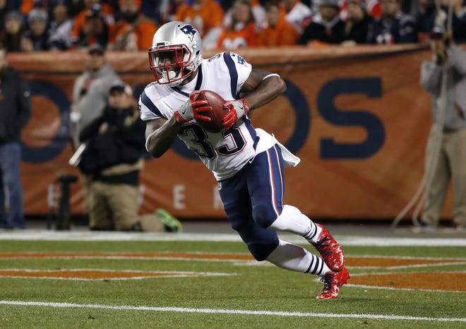 Dion Lewis runs back a kickoff for a touchdown during the first half of 41-16 Patriots win over the Broncos on Sunday night in Denver. [AP Photo/Jack Dempsey]