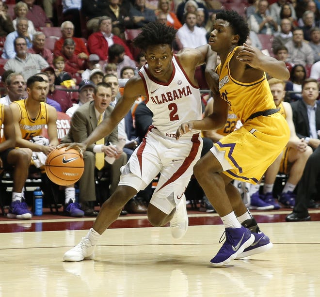 Alabama guard Collin Sexton (2) drives around Lipscomb guard Kenny Cooper during the Cimson Tide's home opener in Coleman Coliseum on Tuesday, Nov. 14, 2017. Sexton led the Crimson Tide with 22 points in the 86-64 win. [Staff Photo/Gary Cosby Jr.]