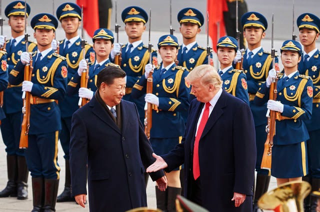 TALKING POINTS — From left, China’s President Xi Jinping and U.S. President Donald Trump shake hands on Nov. 9 during a meeting outside the Great Hall of the People in Beijing, China. (Artyom Ivanov/Tass/Abaca Press/TNS)