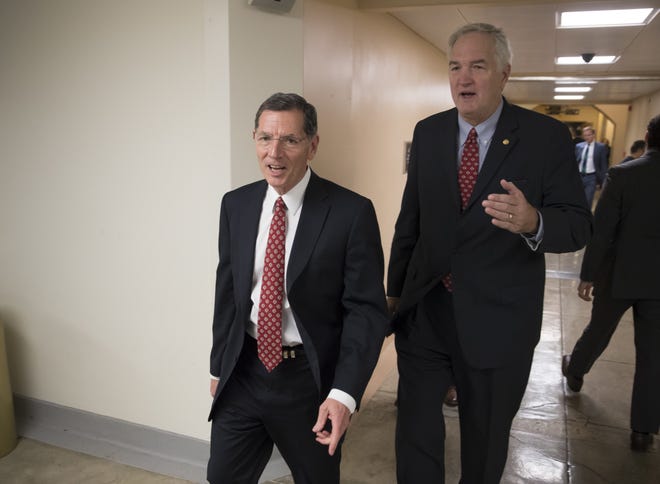 Sen. John Barrasso, R-Wyo., chairman of the Senate Environment and Public Works Committee, left, and Sen. Luther Strange, R-Ala., leave the Senate following an Oct. 25 vote at the Capitol. Sen. Barrasso's committee voted along party lines to advance President Trump's picks for key posts at the EPA, including Michael Dourson, over the objections of Democrats who pointed to the nominees' past work for corporate clients they would now regulate. [J. Scott Applewhite/AP photo]