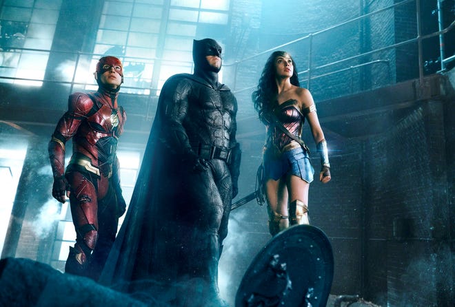 This image Ezra Miller, from left, Ben Affleck and Gal Gadot in a scene from "Justice League." [Warner Bros. Pictures]