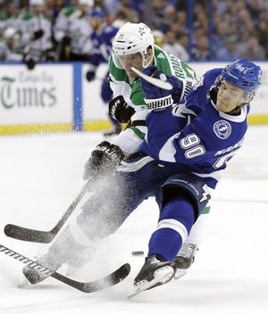 Tampa Bay Lightning center Vladislav Namestnikov (90) is taken down by Dallas Stars left wing Antoine Roussel during the second period Thursday in Tampa. [The Associated Press / Chris O'Meara]
