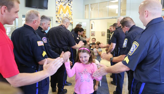 Students get high fives from local first reponders during "High Five Friday at the Mary K. Goode and Henry B. Burkland schools. [Cindy DiStefano/The Gazette/SCMG]