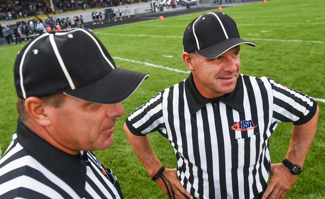 RON JOHNSON/JOURNAL STAR FILES

Twins Pete McGinnes, left, and Bud McGinnes work a game together earlier this season. The brothers are set to work the Class 3A state championship game Thanksgiving weekend in DeKalb.