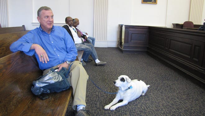 Bill Feldman and his partner Henry wait their turn in New Hanover Count District Court on Friday for Operation Clean Slate. Feldman was cited for Henry, his PTSD service dog, not being leashed. [F.T. Norton/StarNews]