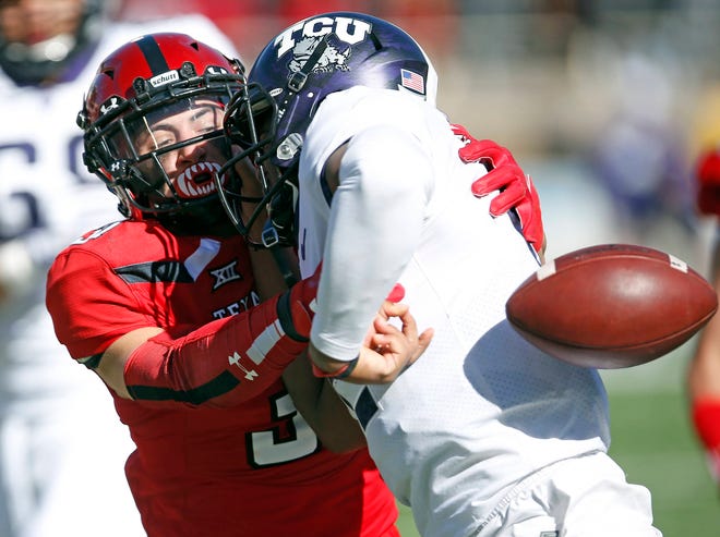 Texas Tech’s Justus Parker (31) punches the ball away from TCU’s Shawn Robinson (12) during the second half of the NCAA college football game Saturday, Nov. 18, 2017, in Lubbock, Texas. (AP Photo/Brad Tollefson)