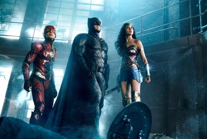 This image released by Warner Bros. Pictures shows Ezra Miller, from left, Ben Affleck and Gal Gadot in a scene from “Justice League.” (Warner Bros. Entertainment Inc. via AP)