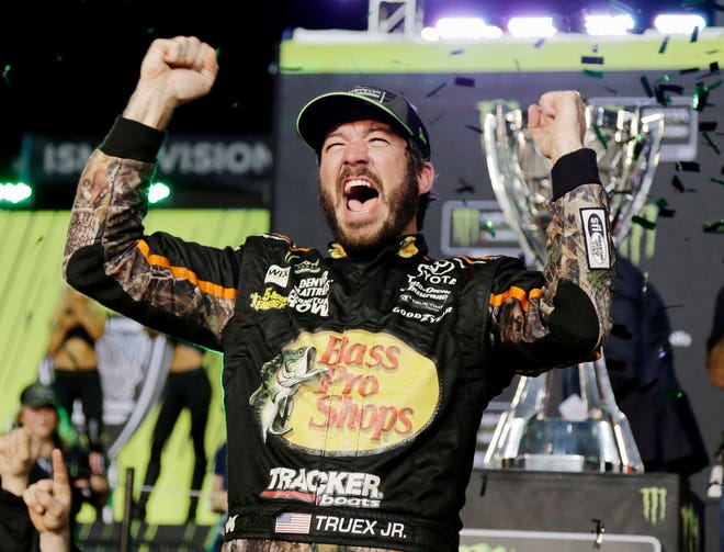 Martin Truex Jr. celebrates in Victory Lane after winning the NASCAR Cup Series race and season championship at Homestead-Miami Speedway on Sunday. [Associated Press/Terry Renna]