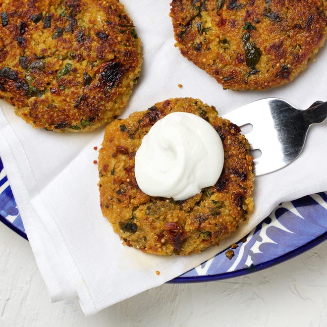 Flavorful quinoa cakes are seasoned with spinach and sun-dried tomatoes. [Deb Lindsey / The Washington Post]