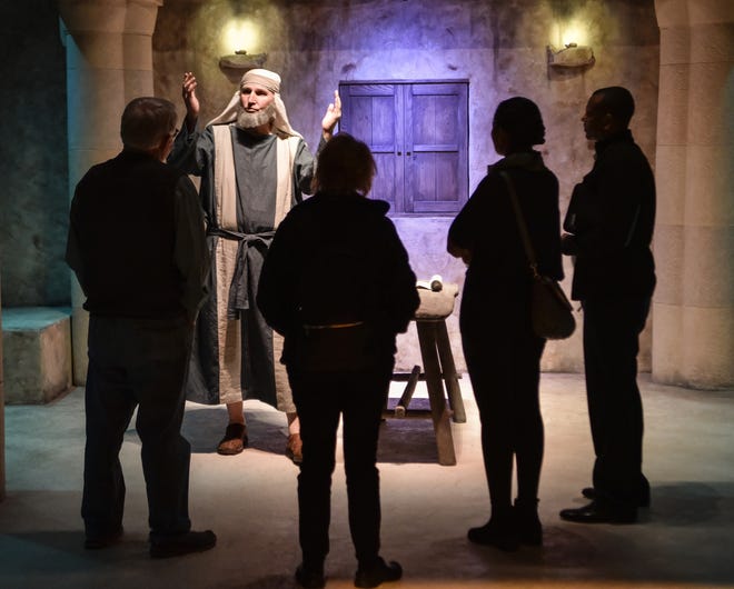 A group listens to a New Testament reenactor talk about the biblical era in Jerusalem at an exhibit at the Museum of the Bible. The $500 million institution opened to the public Saturday. [The Washington Post / Bill O'Leary]