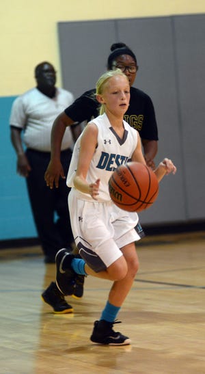 Destin's Lexi Roberts moves the ball down the floor for the Marlins. Destin beat Meigs in middle school basketball 43-15. [TINA HARBUCK/THE LOG]