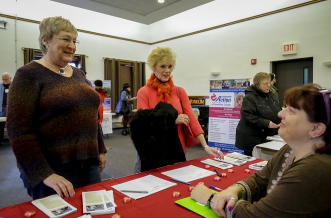 Nancy Little, left, of Dover and Judy Morrison of Durham talk with Susan Ford of My Friends Place during the Volunteer Fair on Saturday at the Dover Public Library. [Shawn St. Hilaire/Fosters.com]