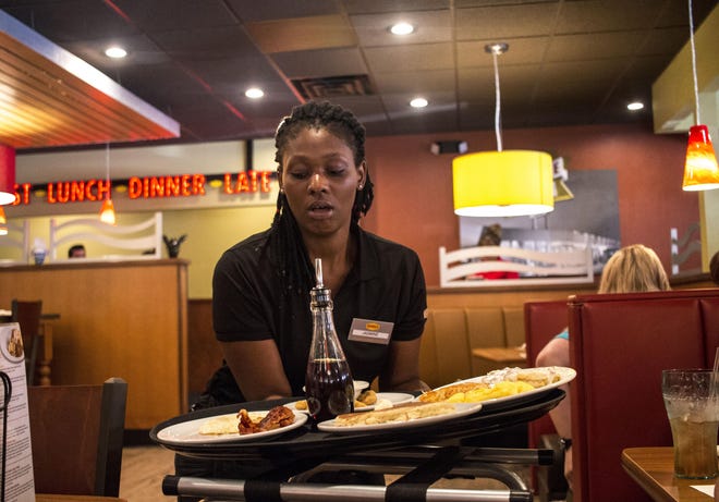 Jasmine Williams serves food at Denny's in this Gazette file photo. Denny's will be one of several restaurants open Thanksgiving Day. [PHOTO BY DEMETRIA MOSLEY/THE GASTON GAZETTE]