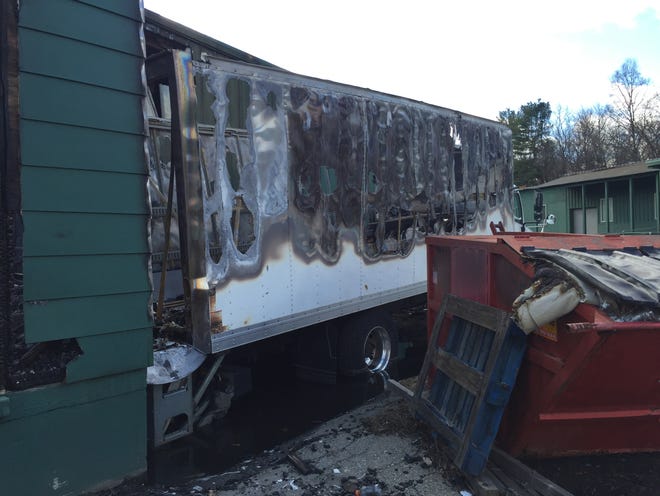 Besides the building at 9 Railroad Ave. in Millbury, a delivery truck was damaged by a fire Saturday night. [T&G Staff/Scott O'Connell]