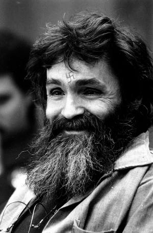 In this Feb. 4, 1986, file photo, convicted murderer Charles Manson looks towards the parole board in San Quentin, Calif. Authorities say Manson, cult leader and mastermind behind 1969 deaths of actress Sharon Tate and several others, died on Sunday, Nov. 19, 2017. He was 83.(AP Photo/Eric Risberg, File)