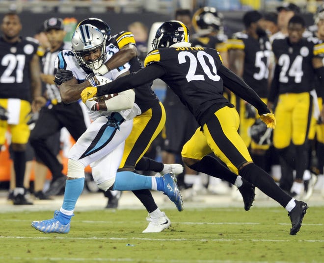 Carolina Panthers' Cameron Artis-Payne (34) is tackled by Pittsburgh Steelers' Cameron Sutton (20) in the first half of an NFL preseason football game in Charlotte, N.C. on Aug. 31, 2017. Sutton was activated from injured reserve Tuesday. [AP Photo/Mike McCarn]