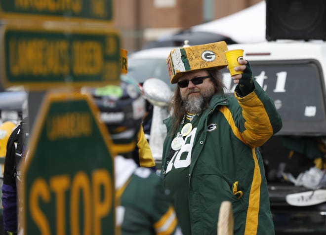 Green Bay Packers fans tailgate outside Lambeau Field before an NFL football game against the Baltimore Ravens Sunday, Nov. 19, 2017, in Green Bay, Wis. (AP Photo/Mike Roemer)