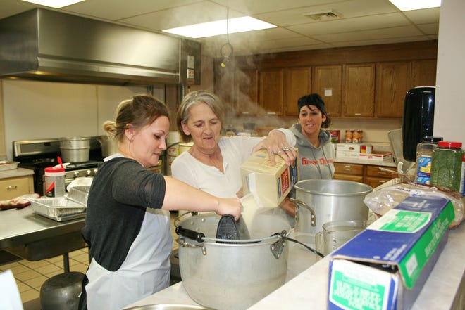 Crystal Ryan, Donnette Wates and Maye Wates work on the mash potatoes at the First United Methodist Church's annual community Thanksgiving dinner Saturday. The full-fixins' meal is provided free each year.