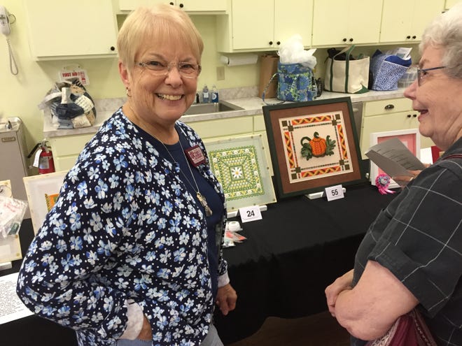 Mary Grosser, organizer of the Fairfield Harbour Contemporary Needle Arts group, chats with JoAnn Bradley at the Needle Arts Exhibition recently held in the Community Center. A wide array of needle art projects were on display to share the talent of many Harbour residents.