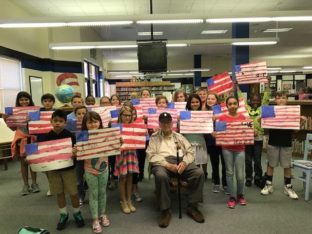 The Kindness and Compassion Club of Brinson Memorial Elementary (BME) presented flag place mats to Mr. Hal Humphrey, a veteran who looks out for other veterans and active duty military. He delivered these handmade place mats to the veterans who live in the VA Hospital in Kinston. With the help of BME art teacher, Mrs. Apple, students in many classes used watercolors to provide some cheer and well wishes to local veterans in honor of Veterans' Day. [SUBMITTED PHOTO]