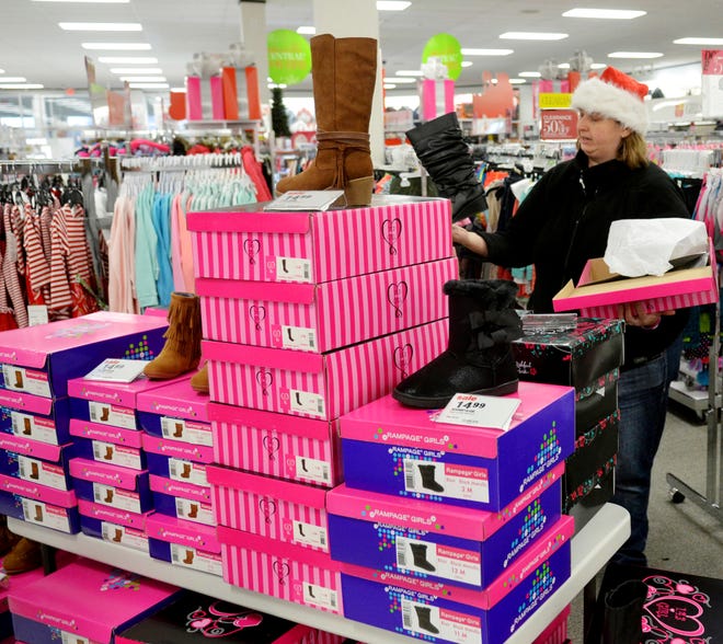Christina Ornelas of Ashtabula checks out some boots at Peebles during the start of the Christmas shopping season, Thursday, Nov. 24, 2016, in Ashtabula, Ohio. After enjoying the Thanksgiving turkey, some Americans hit the stores for what retailers hope will be a new tradition to start the holiday shopping season. (Warren Dillaway/The Star-Beacon via AP)