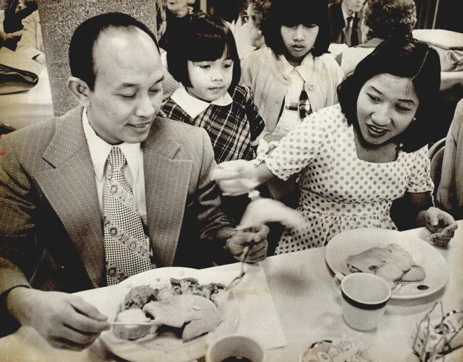 In November 1975, Vietnamese families are honored with a Thanksgiving dinner by the congregation of First Christian Church, 3700 N Walker. It was a special event for the church members and the 50 Vietnamese refugees the church sponsored. [PHOTO BY AUSTIN TRAVERSE, THE OKLAHOMAN ARCHIVES]