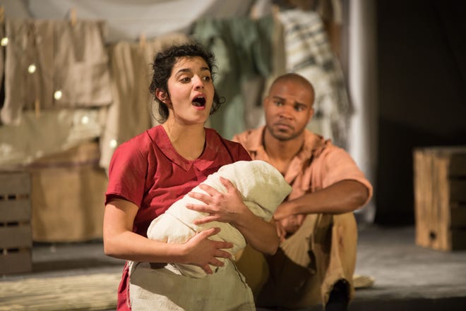 In this scene from the 2016 production of "The Unusual Tale of Mary and Joseph's Baby," Ellen Nikbakht as Mary, holds Baby Jesus as she sings a song, while Joseph, portrayed by Robert George, listens in the background. [Photo provided]