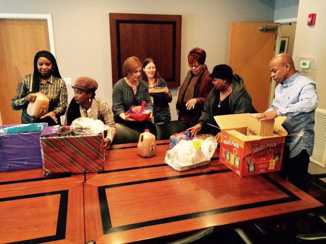 The African-American Network of the Poconos (AAN) delivered community-donated food, baby items, toiletries and other necessities to Women's Resources of Monroe County (WR) for women and children in need Wednesday, Nov. 22, 2017. Pictured from left are T'Shawn Rivers of WR, Cleo Jarvis of AAN, Lauren Peterson and Jenn Dunne of WR and Alice Piper, Sabrina Roberts and Jonathan Edmondson of AAN. (Andrew Scott/Pocono Record)