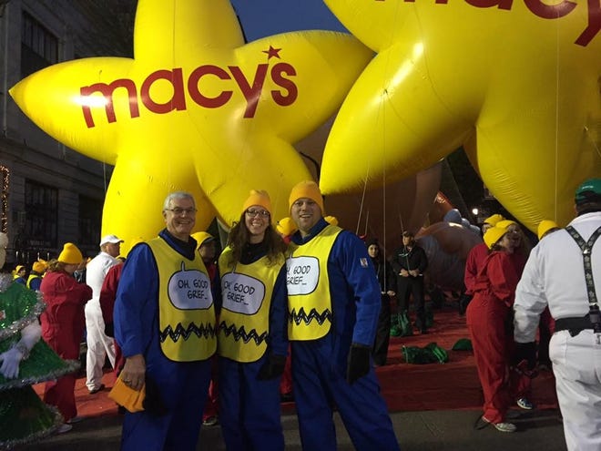 Tom Bontemps, Brittany Bontemps and Christopher DiLeonardo stand in front of some balloons at the Macy's Thanksgiving Day parade in 2016. They guided the Charlie Brown balloon through the streets of New York. [Courtesy of Christopher DiLeonardo]