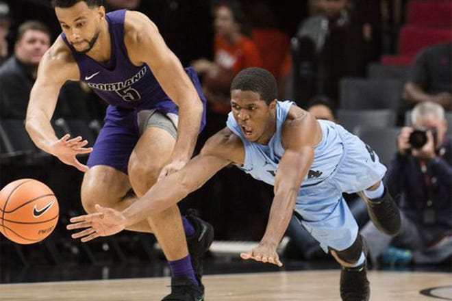 ALL-OUT EFFORT — North Carolina guard Kenny Williams, right, dives for a loose ball against Portland guard D'Marques Tyson.