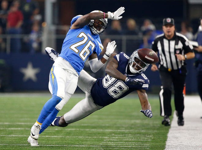 Los Angeles' Casey Hayward (26) breaks up a pass intended for Dallas' Dez Bryant in the second half Thursday in Arlington, Texas. [Associated Press/Ron Jenkins]