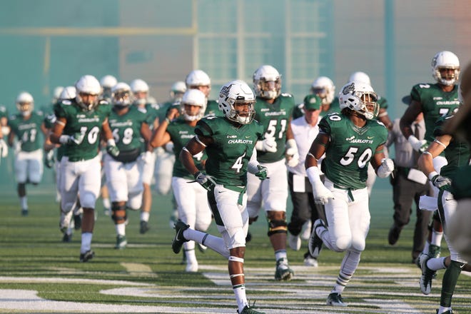 Burns grad and Charlotte 49ers Chris Montgomery (4) runs out of the tunnel before the team's home game against Georgia State on September 23, 2017. (BRIAN MAYHEW / SPECIAL TO THE GAZETTE)